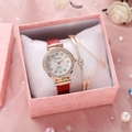 Close-up of rose gold watch and bracelet set with red crocodile leather strap in a gift box - Red And Bracelet And Box