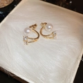 Elegant gold C-shaped earrings with round pearls and small zircon accents on velvet - Gold Pearl Arc (16# Silver Needle)