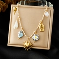 Chic ceramic necklace with fish, sun and shell charms on a braided golden cord - Multi-Pendant Ocean Style (N3584)