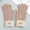 Detail of light brown knitted touchscreen gloves with ribbed cuffs and leather label detail - Khaki