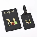 Close-up of black PU leather passport holder and luggage tag set with golden letter M - Black Letter M