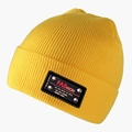Close-up of yellow ribbed knit beanie featuring a black patch with silver metal rivets - L (58-60cm) / Bright Yellow