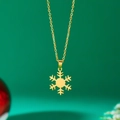 Golden stainless steel snowflake pendant necklace shown against a green background - Snowflake Type A / Gold