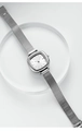 Macro detail of minimalist silver square quartz watch with sleek Milanese mesh strap - Silver White