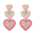 Detail of gold heart earrings with pink beads and crystals in a triple-layered design - Rhinestone Inlaid Heart