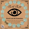 Green stone bead bracelet with evil eye charm on a vintage decorative display card - Green Aventurine Bracelet