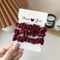 Three-piece set of wine red satin scrunchies displayed on a branded card for women - 3 Piece Set / Burgundy