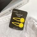Set of two yellow candy-colored smiley face hair clips on a black card display - [20] Smile Face - Yellow