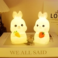 Cute bunny silicone night lights holding carrot and strawberry with warm yellow glow - Strawberry Rabbit