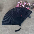 Classic black folding fan with silk floral pattern and decorative tassel on linen - No.23 Black Willow Flower
