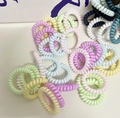 Close-up of assorted macaron colored spiral phone cord hair ties on a textured background - Multicolor Set of 10