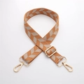 Close-up of orange and beige chevron woven strap with adjustable gold hardware - J44-Orange Beige Herringbone / Bright Silver