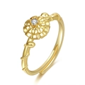 Detailed close-up of a gold-plated flower ring featuring a sparkling white zircon center - November