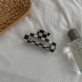 Detail of checkered acetate hair claw clip on white fabric with minimalist decor - Medium Square Claw / Checkered