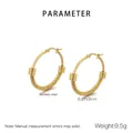 Macro detail of golden stainless steel hoop earrings with spiral texture and triple rings - Spiral Texture with Triple Ring Decor (KE119457-LO)