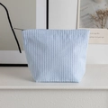 Portable seersucker cosmetic bag featuring a fresh blue and white striped pattern - Light Blue Stripes