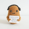 Handmade crochet positive potato doll with headphones holding an encouraging card - Potato with Headphones