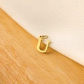 Detailed close-up of a gold-plated letter U pendant on a natural wooden background - 14k Letter - U (letter Height 1cm)