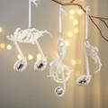 Three white musical note ornaments with glitter and gems on a Christmas tree branch - Crystal Hanging Music Note Set