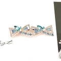 Blue rhinestone crystal bow hair clip with gold alloy base and emerald green gemstones - Double Butterfly Blue