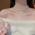 Exquisite pearl flower choker necklace with gold-plated metal flower pendant on a model - Gold White
