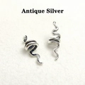 Macro detail of antique silver snake-shaped dreadlock rings with retro hollow texture - White Gold