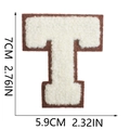 Detail of towel-embroidered letter T patch with white stitching on brown felt base - Letter T