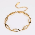 Detail of gold bracelet showing hollow marquise links, zircon stones and K18 hallmark - Gold