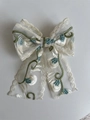 Beige lace bow hair clip with green and light blue floral embroidery in a variant view - Medium - Green Lily