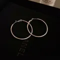 Minimalist silver circular hoop earrings featuring a polished metallic finish and large design - 4cm / Silver