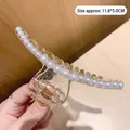 Détail d'une pince à cheveux ambre avec perles et dimensions 11,8x5,0 cm - Pince à Cheveux Barrette Perle Ambre Transparent