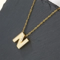 Gold plated letter N necklace with sparkling cubic zirconia on a stone surface - Letter N (Pendant Only)