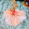 Pink tulle flower keychain with golden coin charm and sparkling rhinestone details - Pink Clover Flower