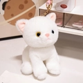 White plush kitten keychain with bicolor eyes and gold metal ring on a desk - White Cat