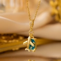 Macro shot of gold-plated travel necklace featuring an airplane and blue suitcase charms - 【yxl9165】gold Airplane Travel Suitcase