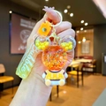 Detail of Mickey-shaped liquid glitter keychain with orange sand and a bubble tag - Orange Sitting Bear with Gradient Rope