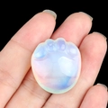 Translucent opalite cat paw crystal stone carving held in hand for desktop decoration - Opalite (Synthetic)