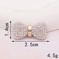 Close-up of pink bow jewelry with white rhinestones and gold center, 2.5cm width - D349 Pink Rhinestone Bowknot