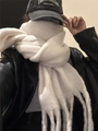 Elegant white mohair scarf with fringe trim worn by a model in a stylish winter outfit - Pure White