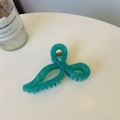 Detail shot of a turquoise ribbon bow hair claw clip with a durable gold-tone metal spring - Dreamy Blue