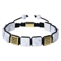 Macro detail of braided bracelet with square white stone and gold zircon accessories - Howlite