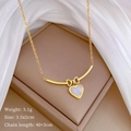 Detail of gold bow necklace with heart pendant, size 3.5x2cm on luxury silk background - Gold (T314)