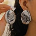 Close-up of large silver hollow mesh oval earrings worn by a model to show scale - Irregular Hollow Mesh Silver (3152)