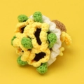 Handmade crochet sunflower pendant with yellow and green yarn on a solid background - Yellow Yarn Hand Bouquet