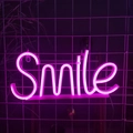 Pink LED neon sign with Smile letter design on transparent base for wall decor - Pink