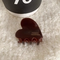 Deep brown heart-shaped acetate hair claw clip with gold lettering on soft plush background - Dark Coffee