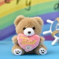 Cute light brown plush teddy bear holding a pink heart with Love is Sweet embroidery. - Love Is Sweet / Tan