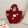 Fuzzy plush red tote bag with white heart patterns and a white brand label - Red Heart Jacquard