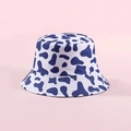 Reversible bucket hat featuring a white and dark blue cow print pattern in cotton - Blue