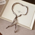 Detail of a brown and white printed silk scarf necklace with adjustable buckle on a tray - 13# White Printed Style